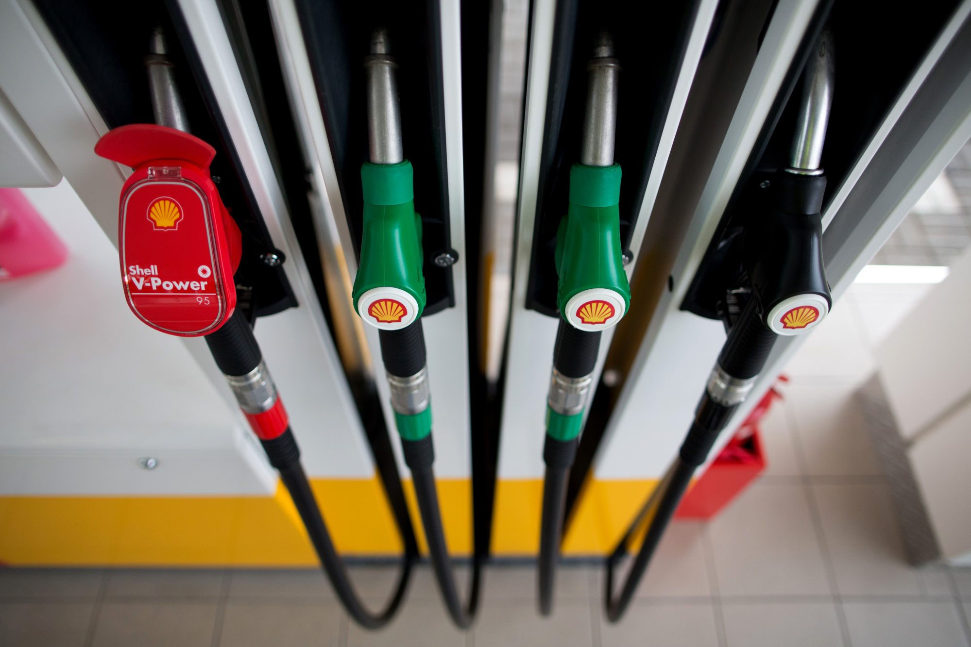 Color coded pump handles at a gas station, operated by Royal Dutch Shell Plc, in Kemerovo, Russia.