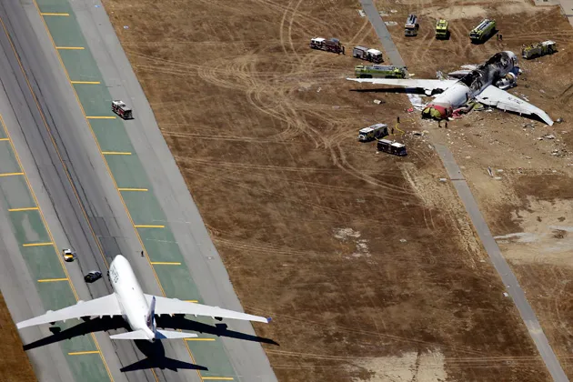 The wreckage of Asiana Flight 214 (right) at San Francisco International airport
