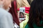 A customer uses FaceTime on an Apple Inc. iPhone device while waiting outside the Apple Inc. store&nbsp;in London, U.K.