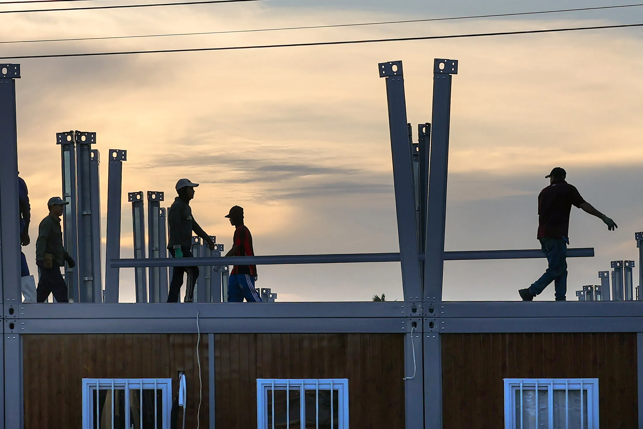 Construction workers at a site where a prefabricated school is being built in the Subryanville neighborhood of Georgetown, Guyana.