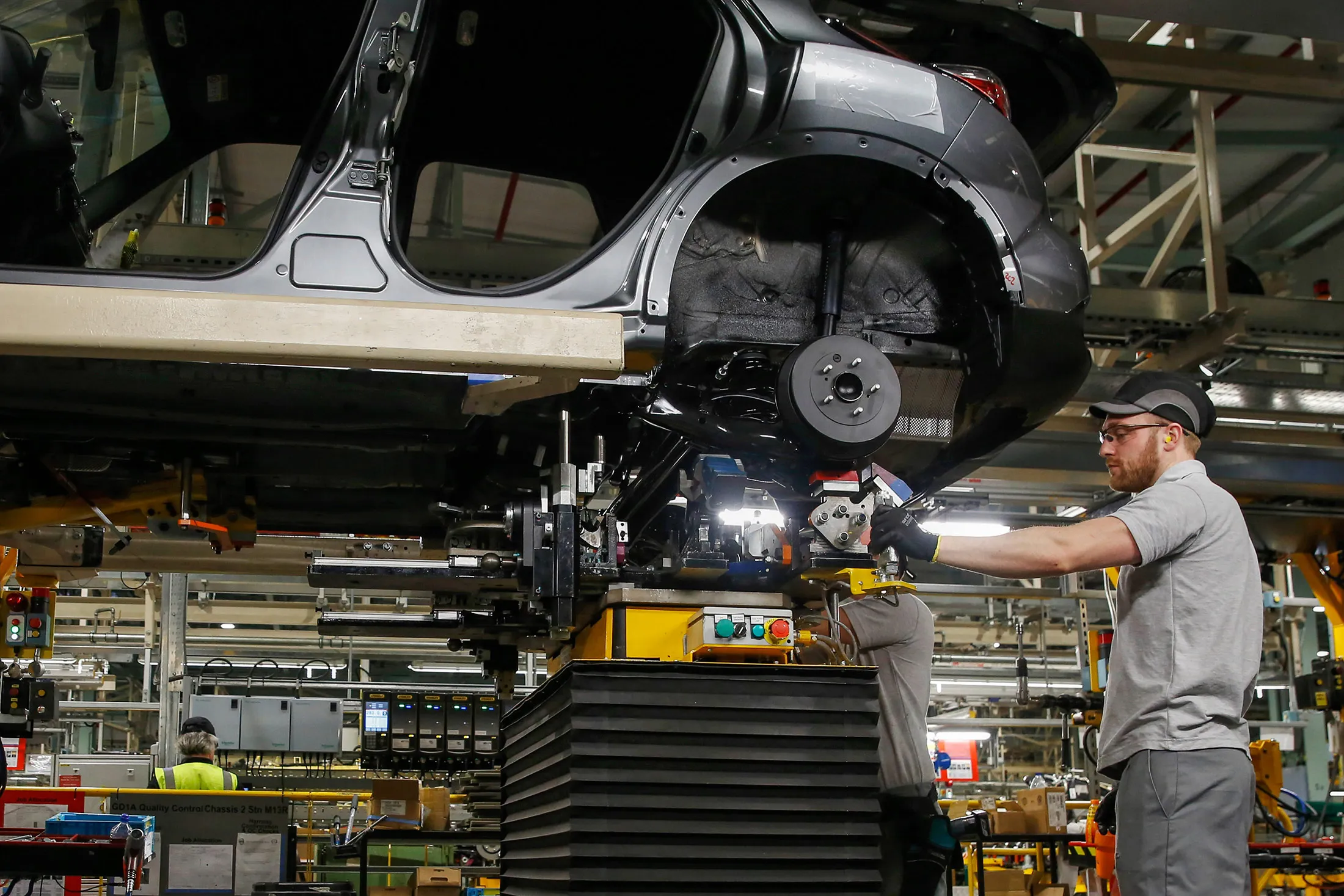 An employee works on a Nissan Juke on the production line at the Nissan Motor Co. production plant in Sunderland.
