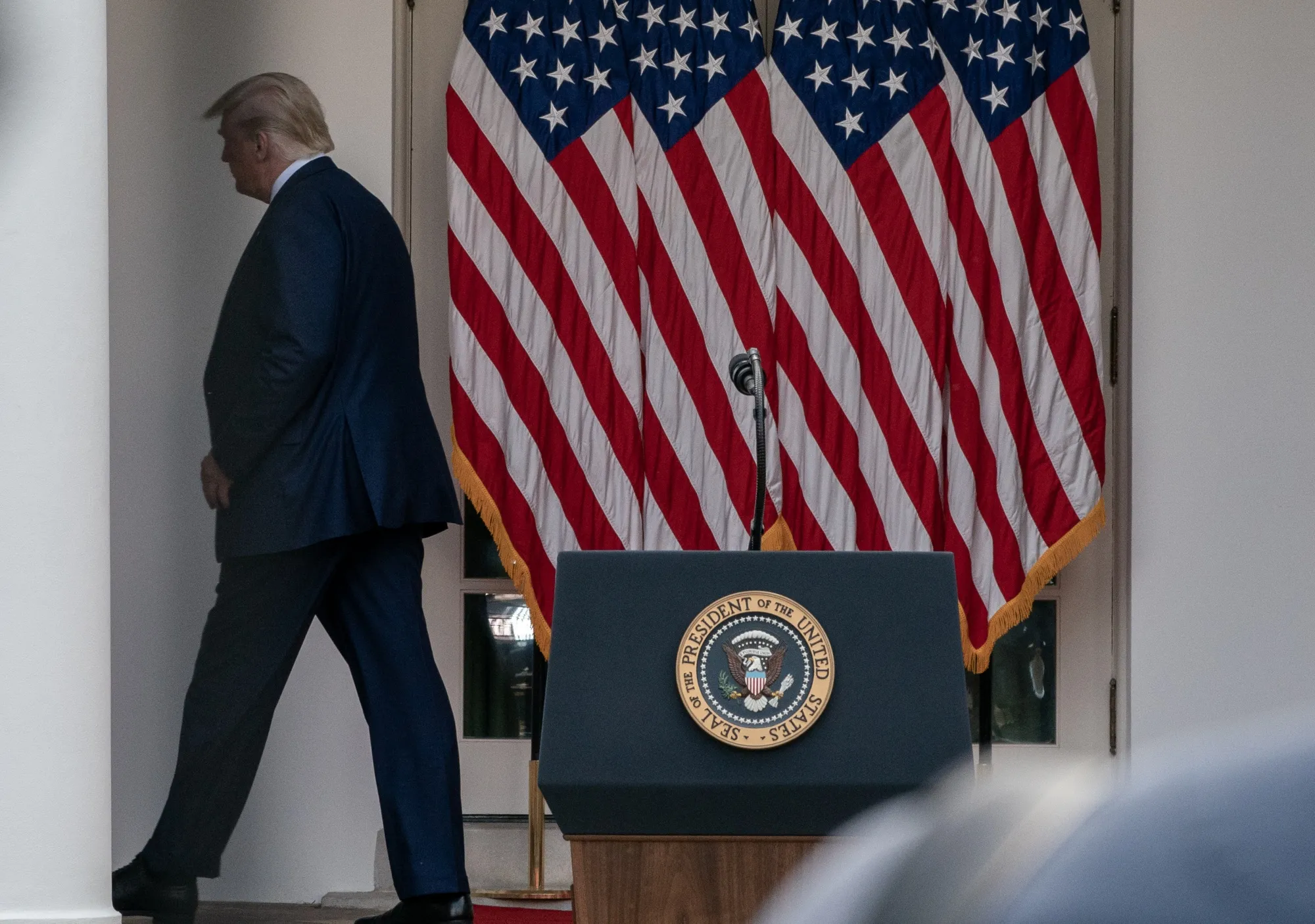 President Donald Trump exits after a&nbsp;Rose Garden news conference.