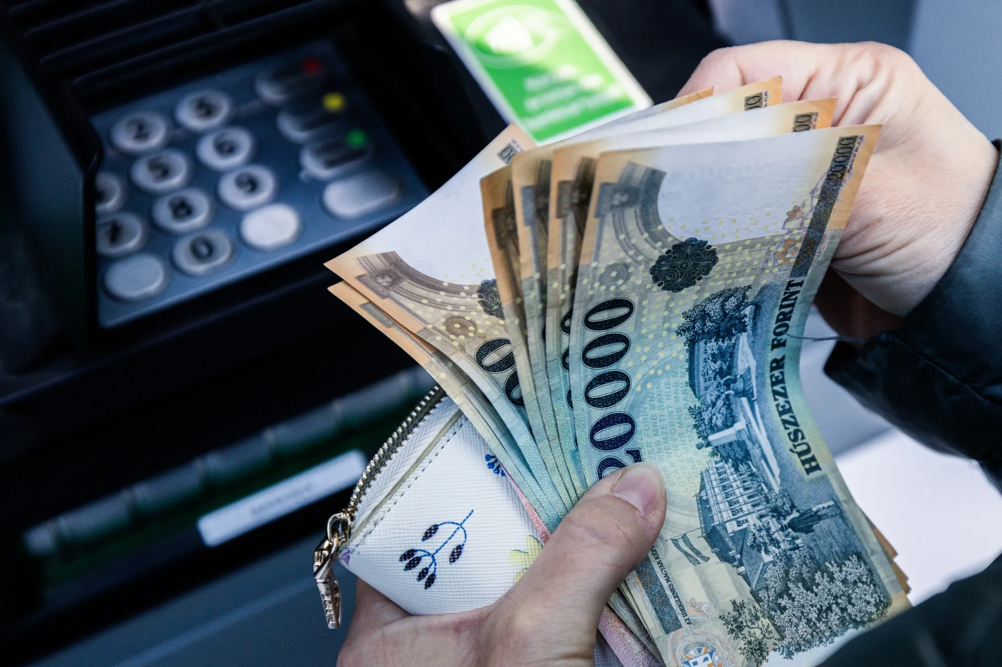 A customer withdraws Forint banknotes&nbsp;in Budapest.