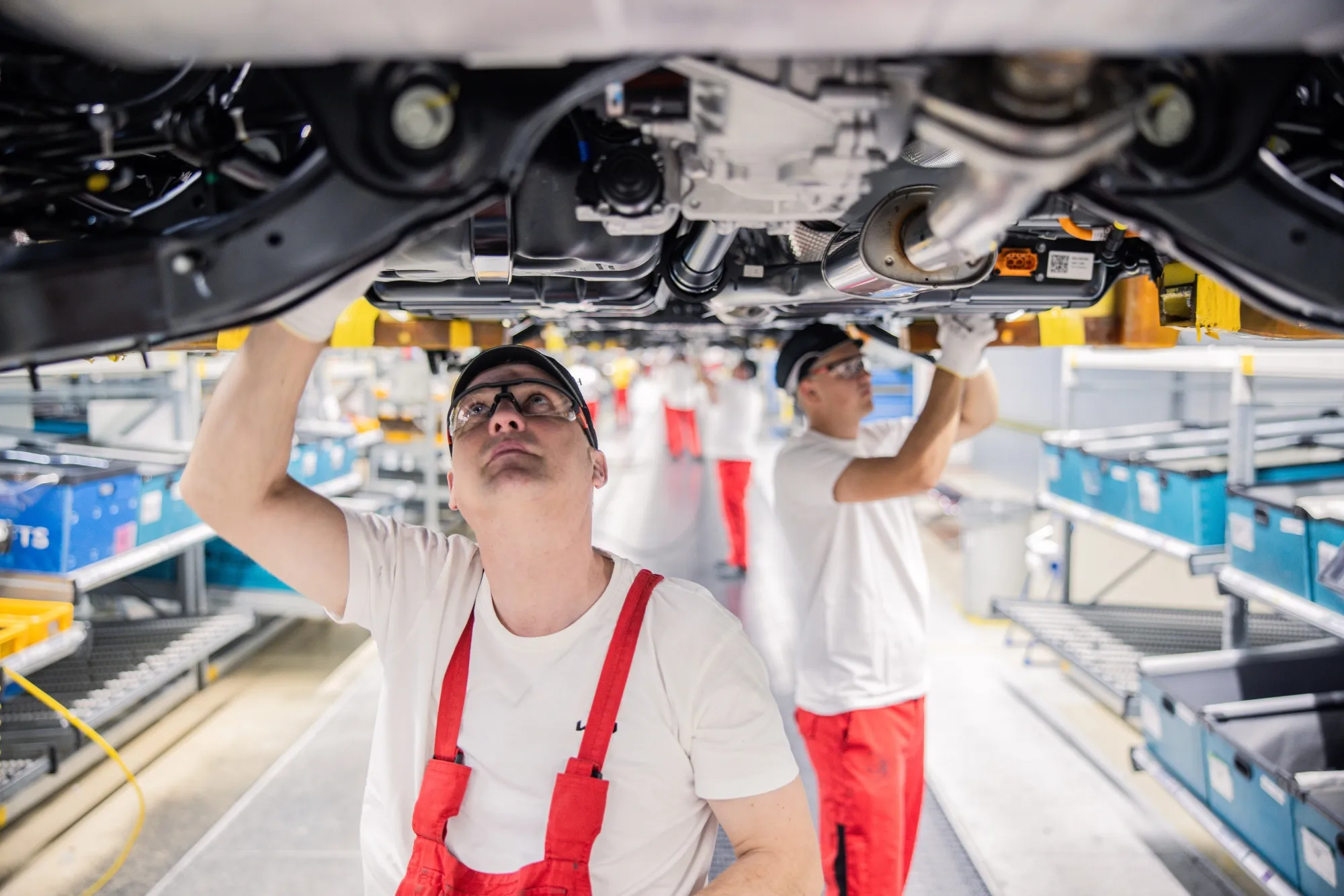 Workers install chassis components at the Kia plant in Zilina, Slovakia.