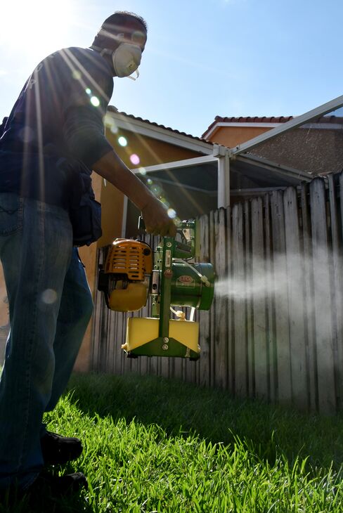 A Miami-Dade County mosquito inspector sprays for mosquitoes.