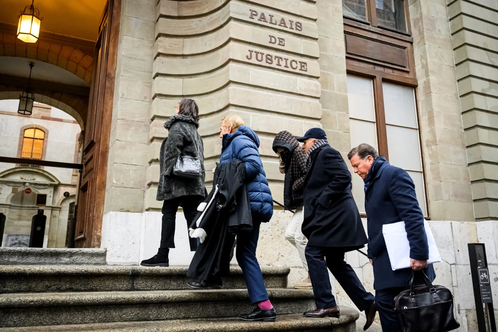 Ajay Hinduja, second right, and his wife, center, arrive with lawyers for the opening day of their trial at the Geneva courthouse, on Jan. 15.&nbsp;