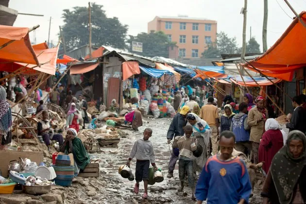 Shoppers and vendors make their way down a street in the Merkato, in Addis Ababa, Ethiopia