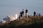 People watch as the SpaceX Falcon Heavy rocket lifts off from launch pad 39A at NASA’s Kennedy Space Center&nbsp;in Titusville, Florida&nbsp;on April 11.