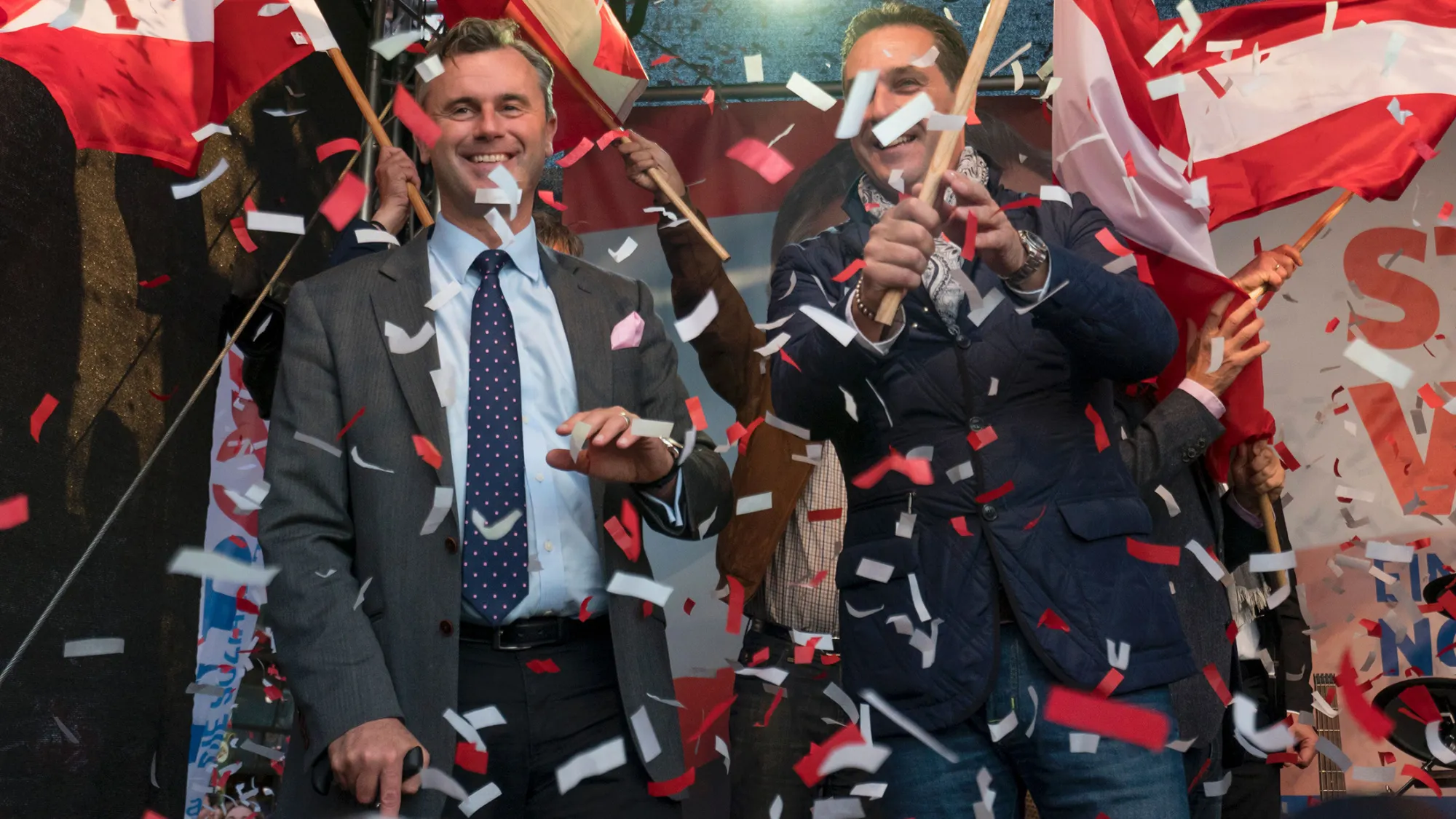 Austrian Freedom Party (FPOe) presidential candidate Norbert Hofer, left, and leader of the FPOe Heinz-Christian Strache wave flags on stage during Hofer's final election campaign rally at the Viktor Adler Markt in Vienna, Austria on May 20,2016.
