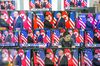 A man stands at a counter as television screens display a news broadcast of U.S. President Donald Trump and North Korean leader Kim Jong Un shaking hands following a document-signing event in Singapore, in an electronics store in Seoul, South Korea, on Tuesday, June 12, 2018. U.S. President Donald Trump and Kim Jong Un signed a declaration that North Korea would work toward "complete denuclearization of the Korean peninsula," while leaving undefined the path to eliminating Pyongyang's nuclear arsenal.