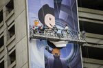 Workers install a billboard for GitHub Inc. in San Francisco.