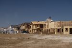 Contractors work on homes under construction in Antioch, California.
