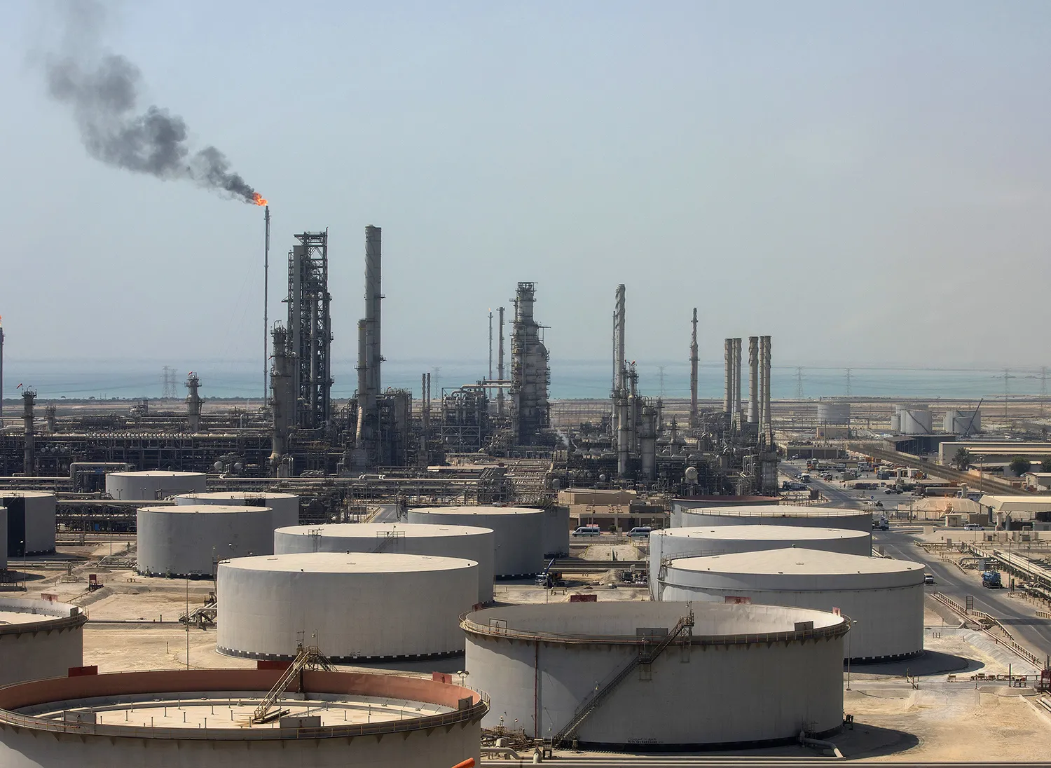Crude oil storage tanks stand at the oil refinery operated by Saudi Aramco in Ras Tanura, Saudi Arabia.
