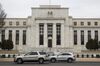 Vehicles pass in front of the U.S. Federal Reserve building in Washington, D.C., U.S. on Thursday, Feb. 22, 2018.