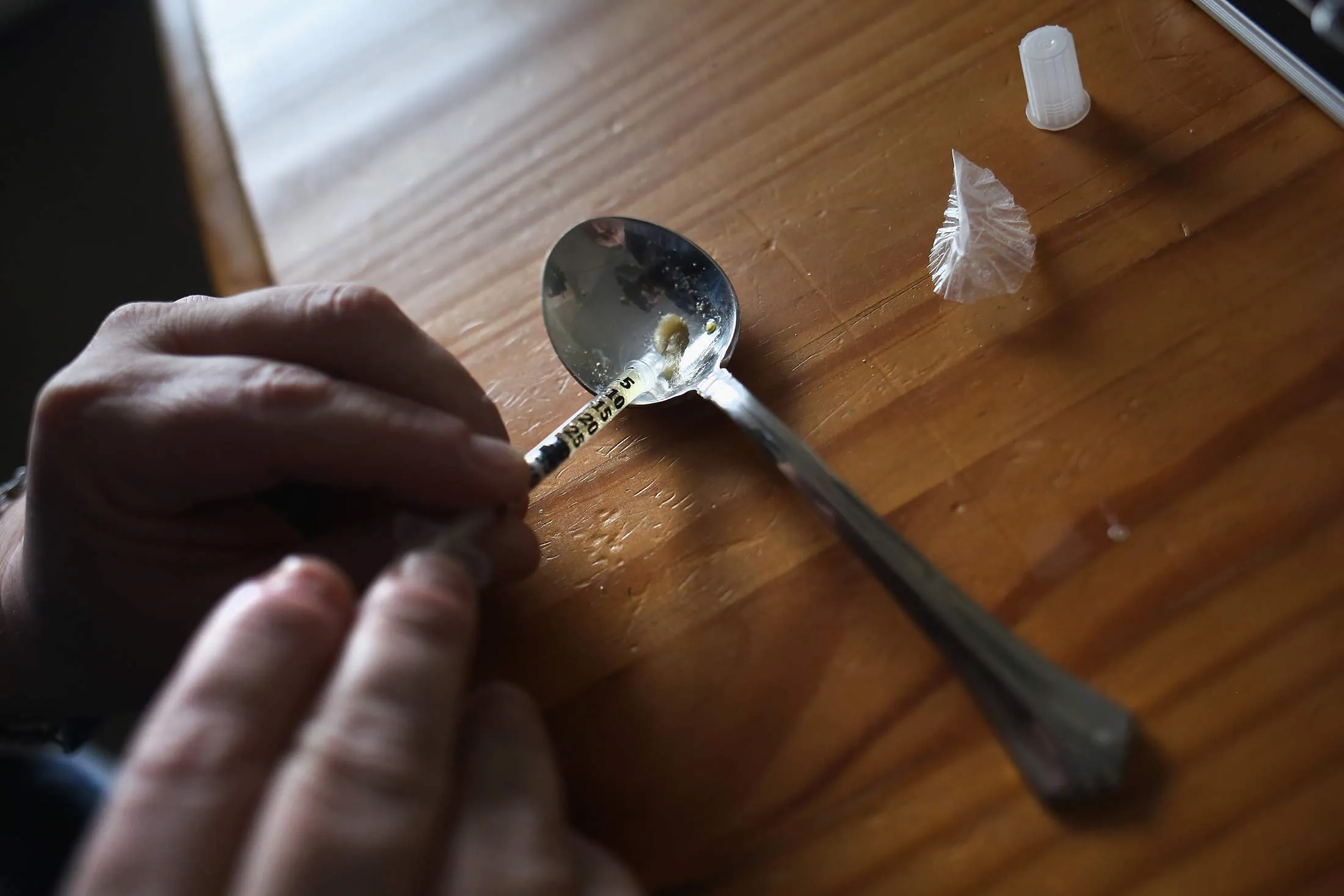 A heroin user prepares to inject himself on March 23, 2016, in New London, Conn.
