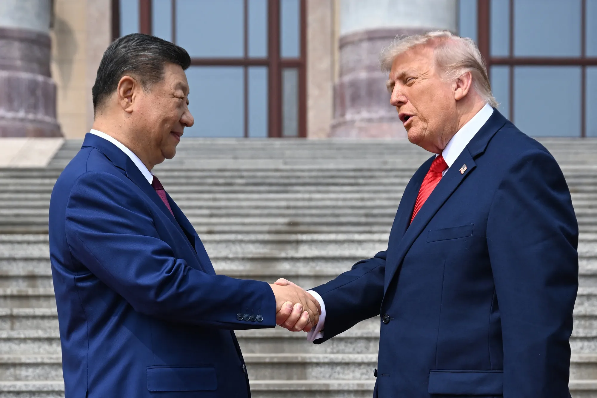 US President Donald Trump shakes hands with Chinese President Xi Jinping at the Great Hall of the People in Beijing on May 14.
