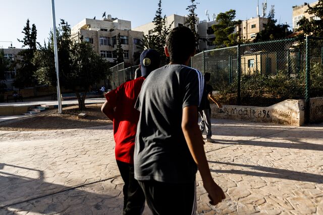 Children kick their ball into the mini-forest at Al-Abdalat Public Park.