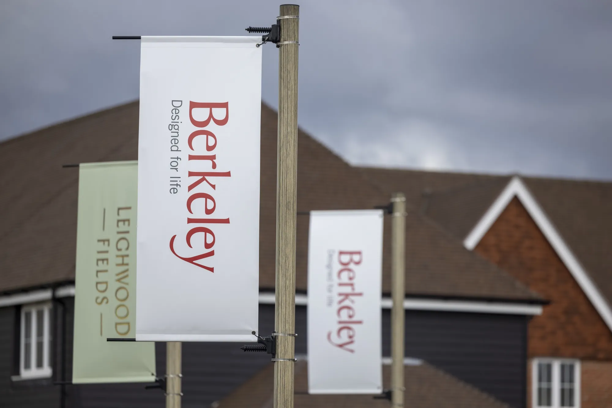 Banners at the entrance to a Berkeley Group Holdings Plc residential construction site in Cranleigh, UK, in February 2024.