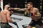 Dustin Poirier punches Conor McGregor on UFC Fight Island on Jan. 23.&nbsp;