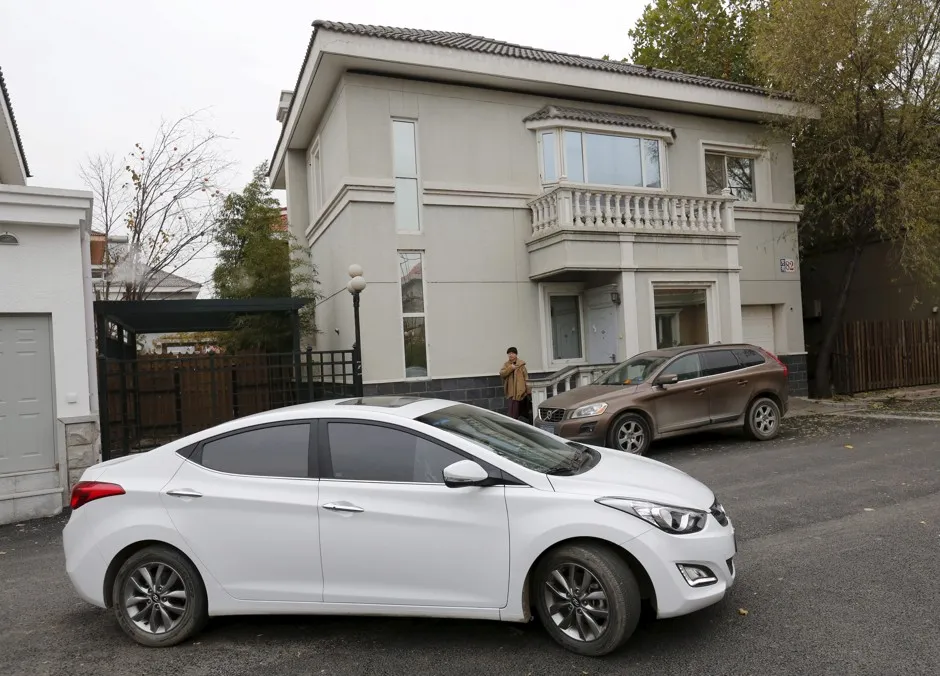Yoko Wu walks toward an Uber car as she leaves her house in Shunyi District, a Beijing suburb. 