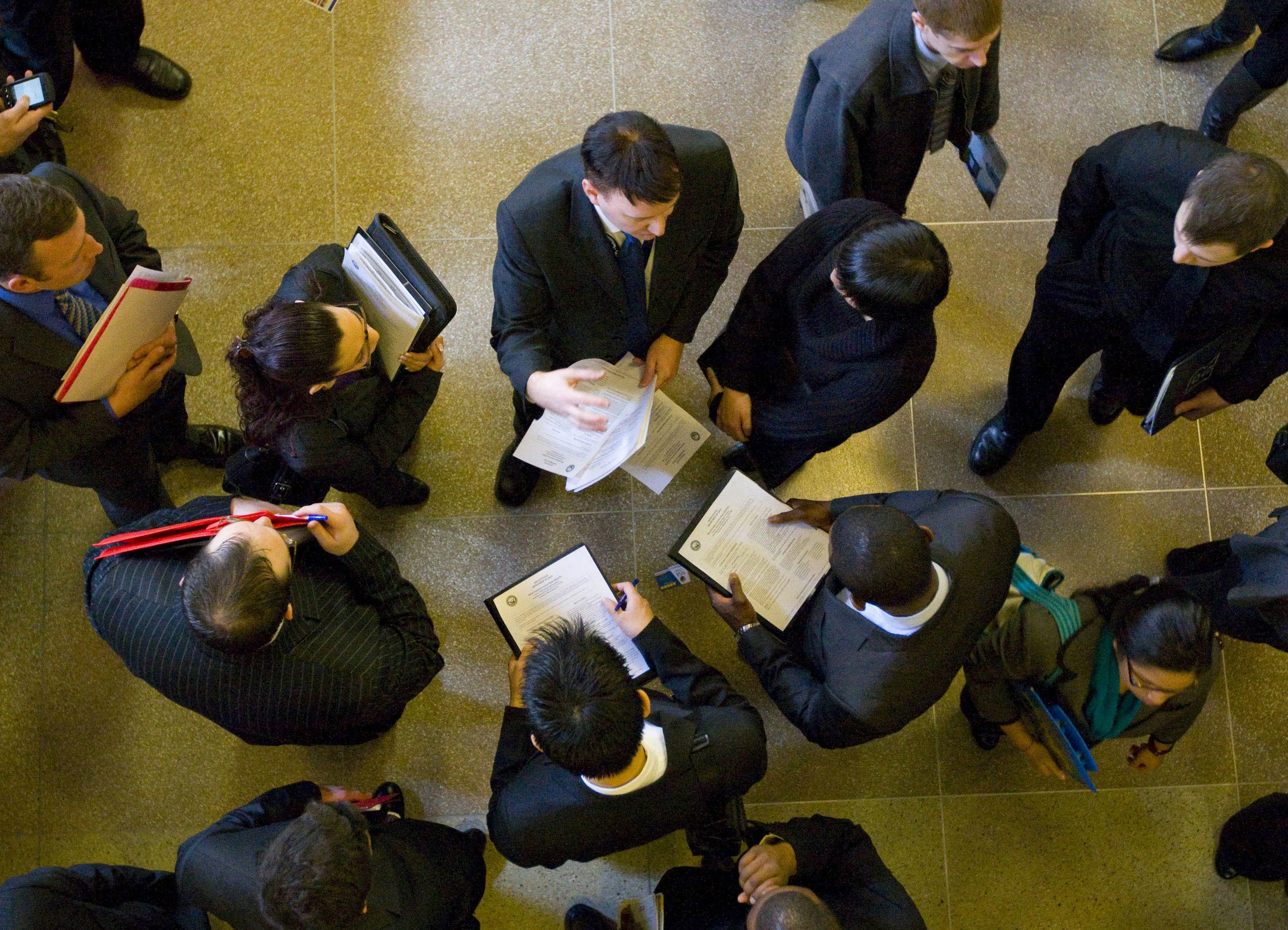 A job recruiter speaks to job seekers at a&nbsp;job fair in New Brunswick, New Jersey.