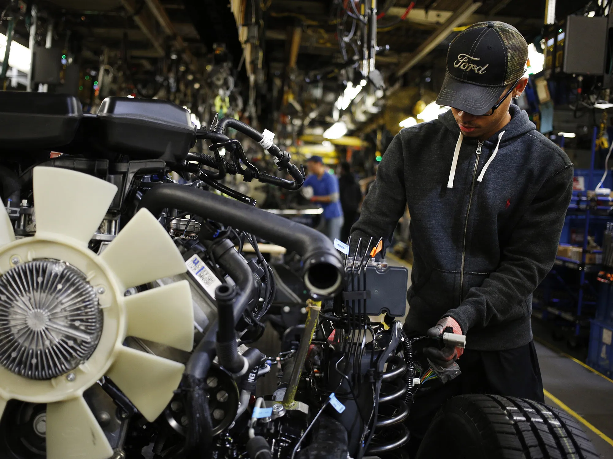An employee works on a Ford Motor Co. Super Duty Truck engine at the Ford Kentucky Truck Plant in Louisville.