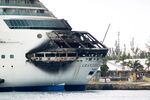 The fire-damaged exterior of Royal Caribbean’s Grandeur of the Seas cruise ship docked in Freeport, on the island of Grand Bahama, on May 27, 2013