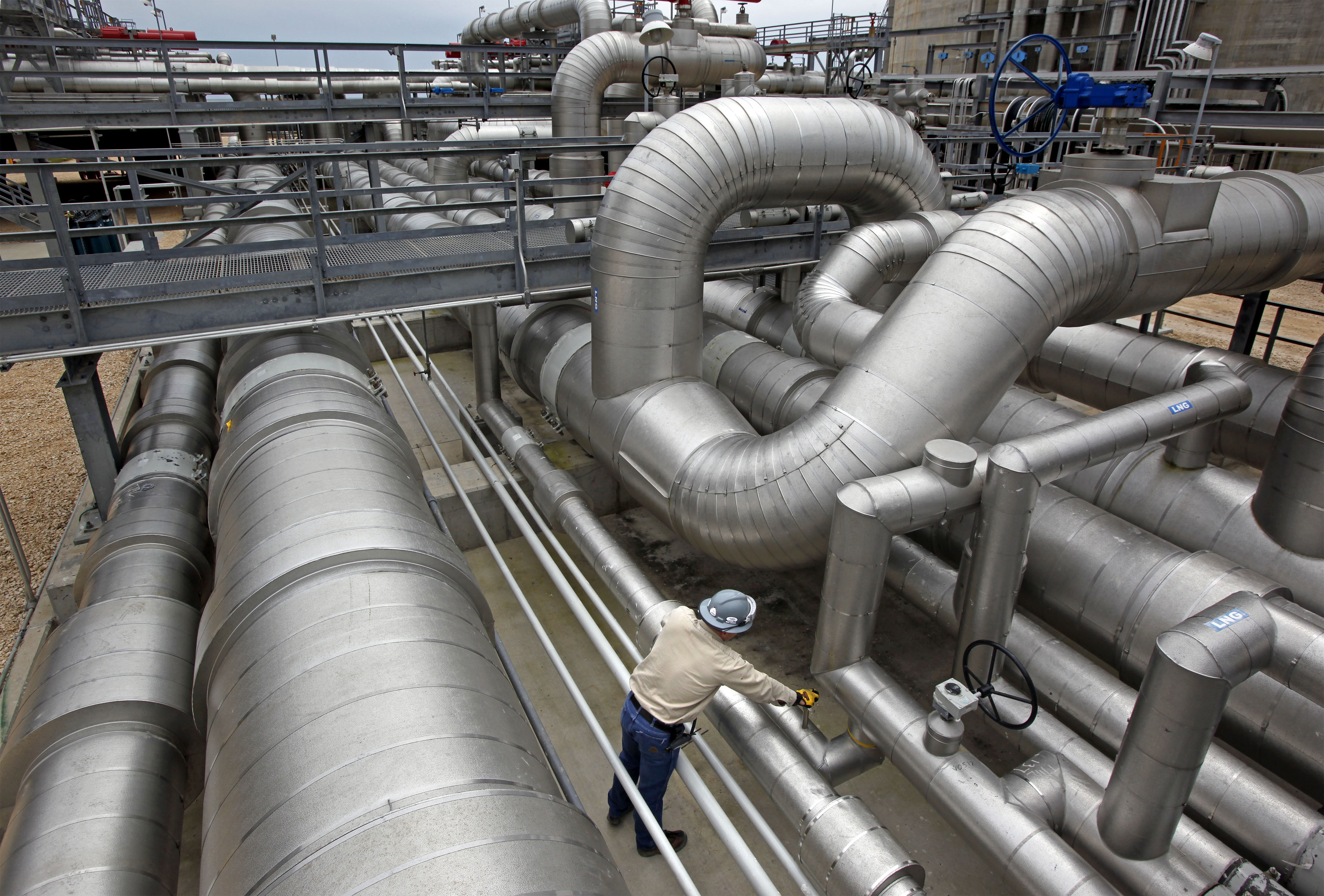 An employee checks valves at the Freeport LNG facility in Quintana, Texas, U.S.&nbsp;