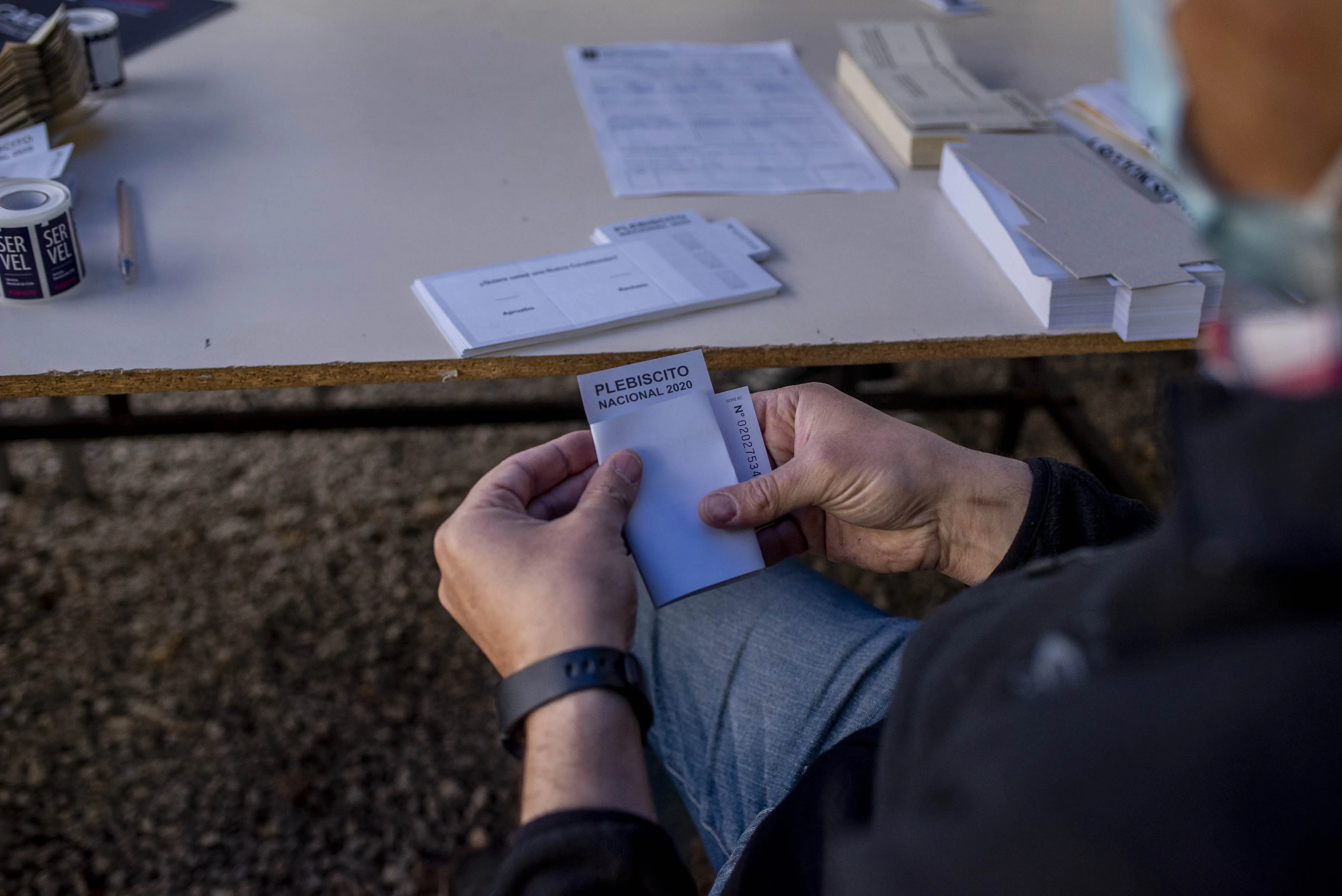An election official prepares a ballot at a polling station during the national referendum in Santiago, Chile, on Sunday, Oct. 25 2020.