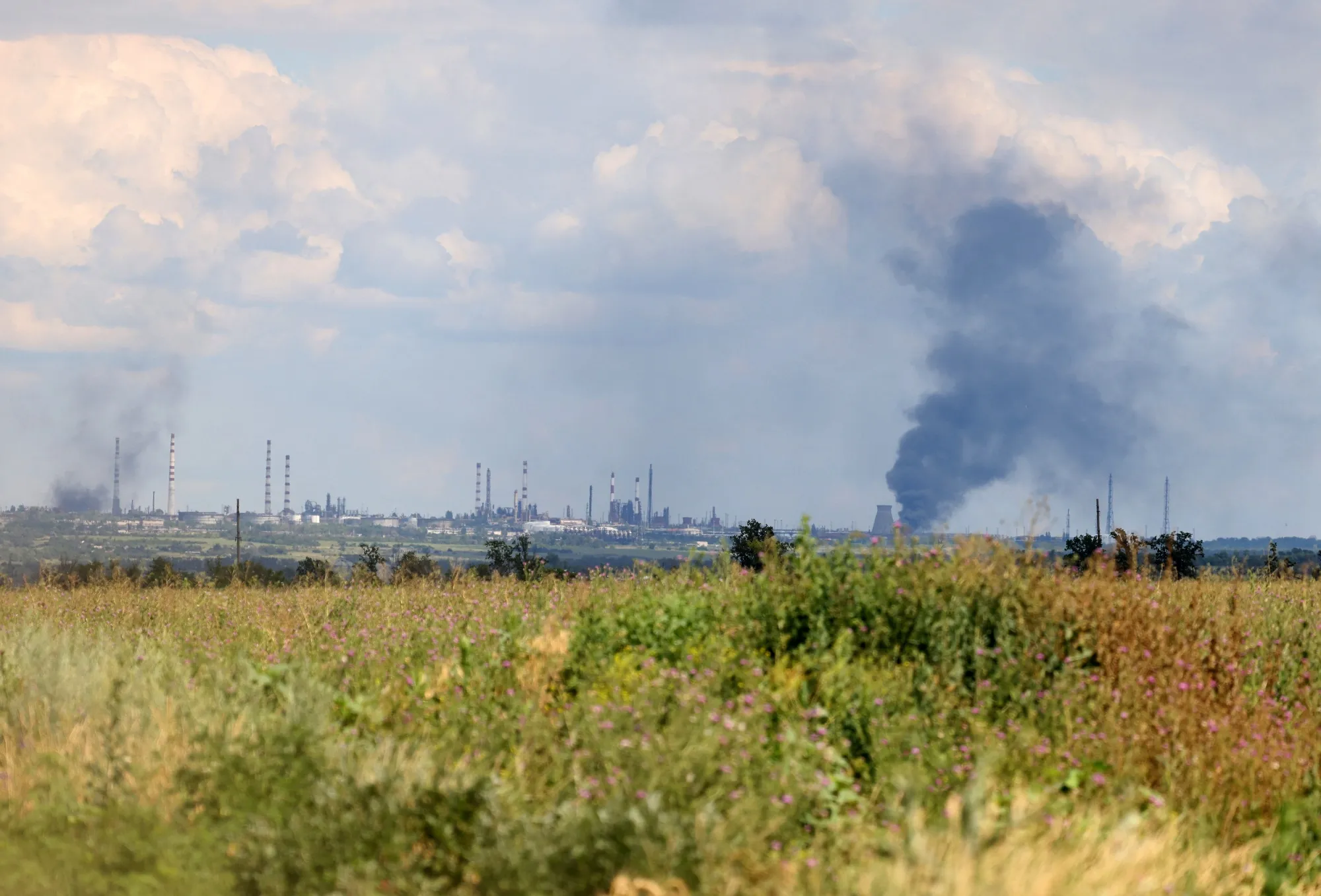 Smoke billowing over the oil refinery outside Russian-occupied Lugansk region in July 2023.&nbsp;