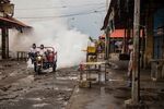 Workers spray disinfectant in a market in Maracaibo on May 28.
