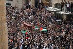 Palestinian mourners carry the casket of Shireen Abu Akleh, near Jaffa Gate, Jerusalem, on May 13.