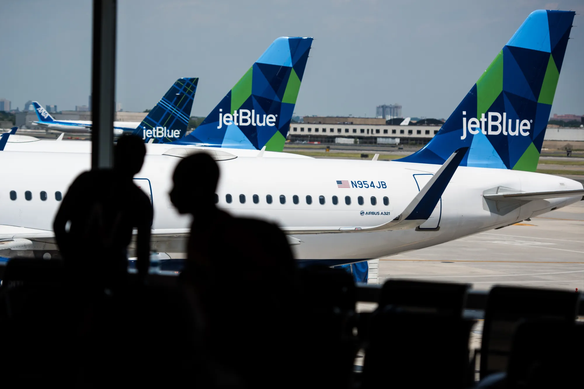 A JetBlue Airbus A321 plane sits at a gate&nbsp;at John F. Kennedy International Airport in New York.&nbsp;