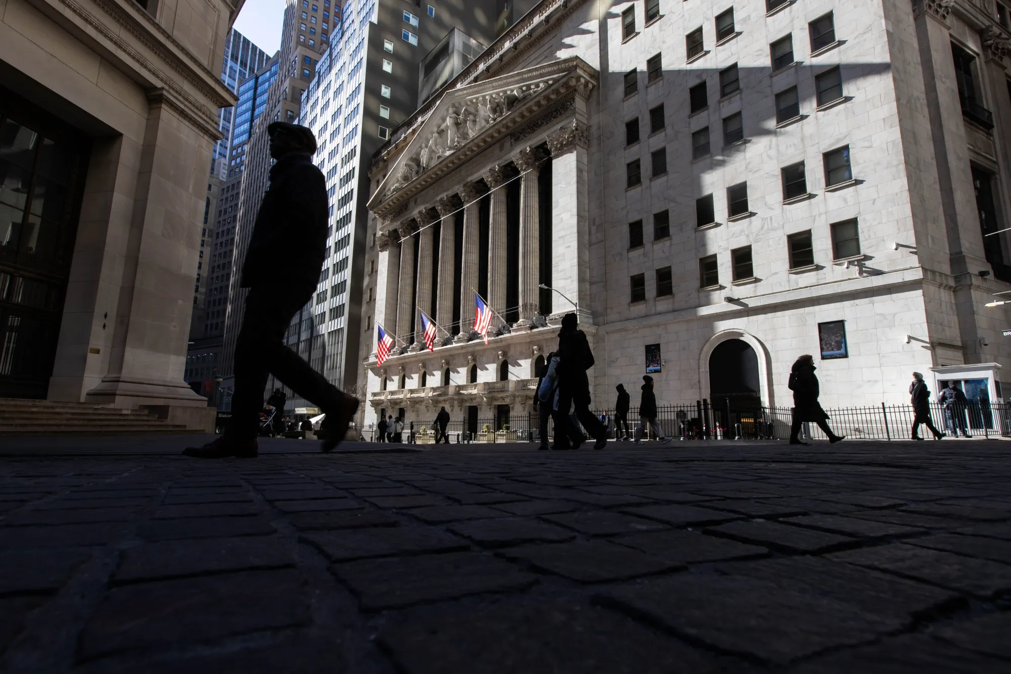 Pedestrians outside of the New York Stock Exchange on Wall Street.&nbsp;