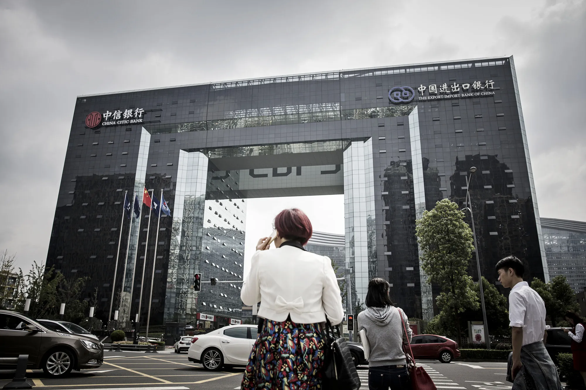 A&nbsp;building displaying signage for the Export-Import Bank of China, right, in the central business district of Chengdu, China.