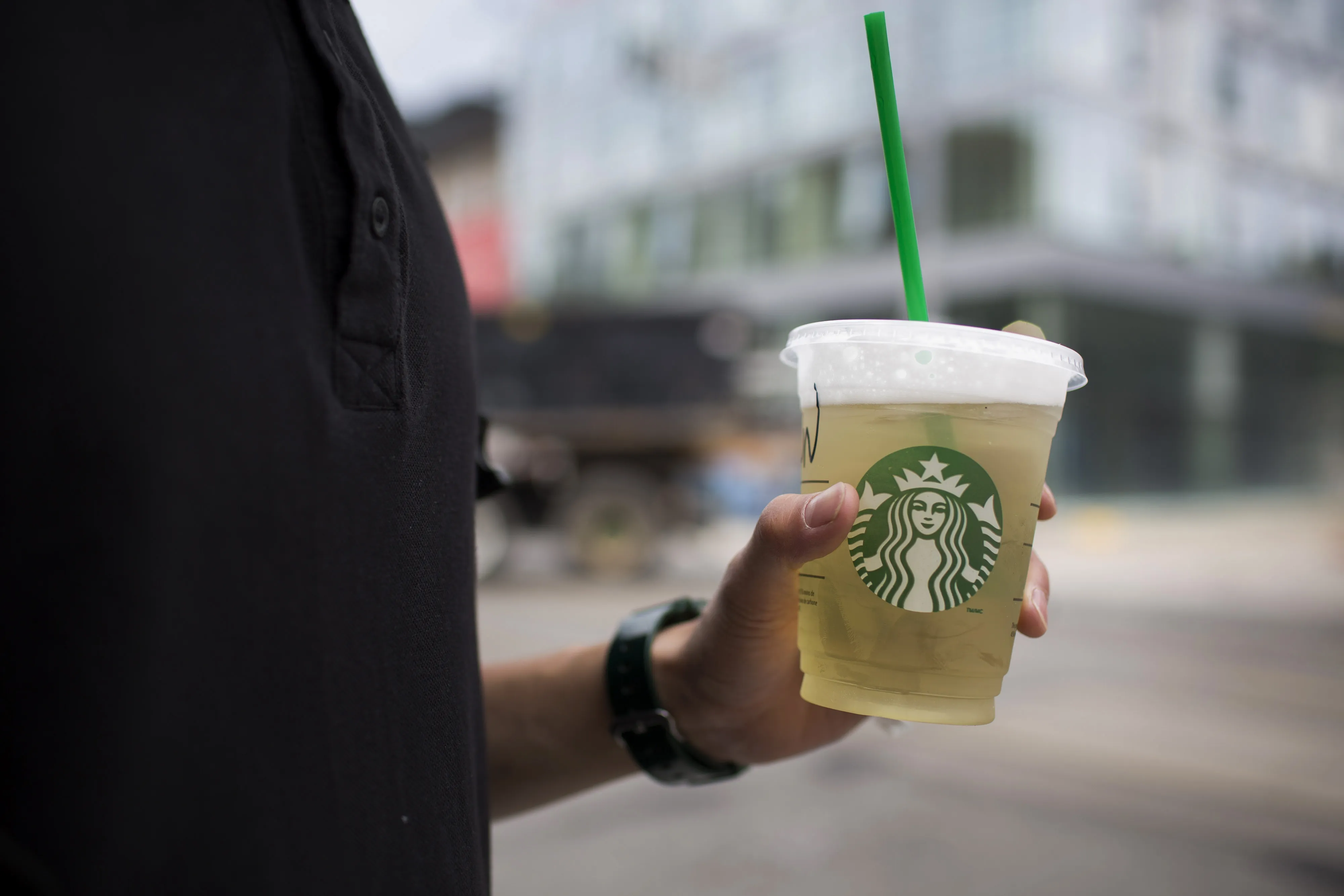 A person holds a Starbucks beverage in Toronto.