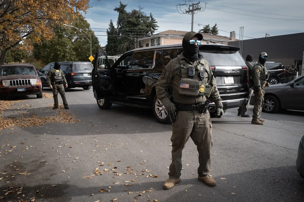 Federal agents stand guard as they are confronted by residents after making a stop in the Brighton Park neighborhood in Chicago on Nov. 6.