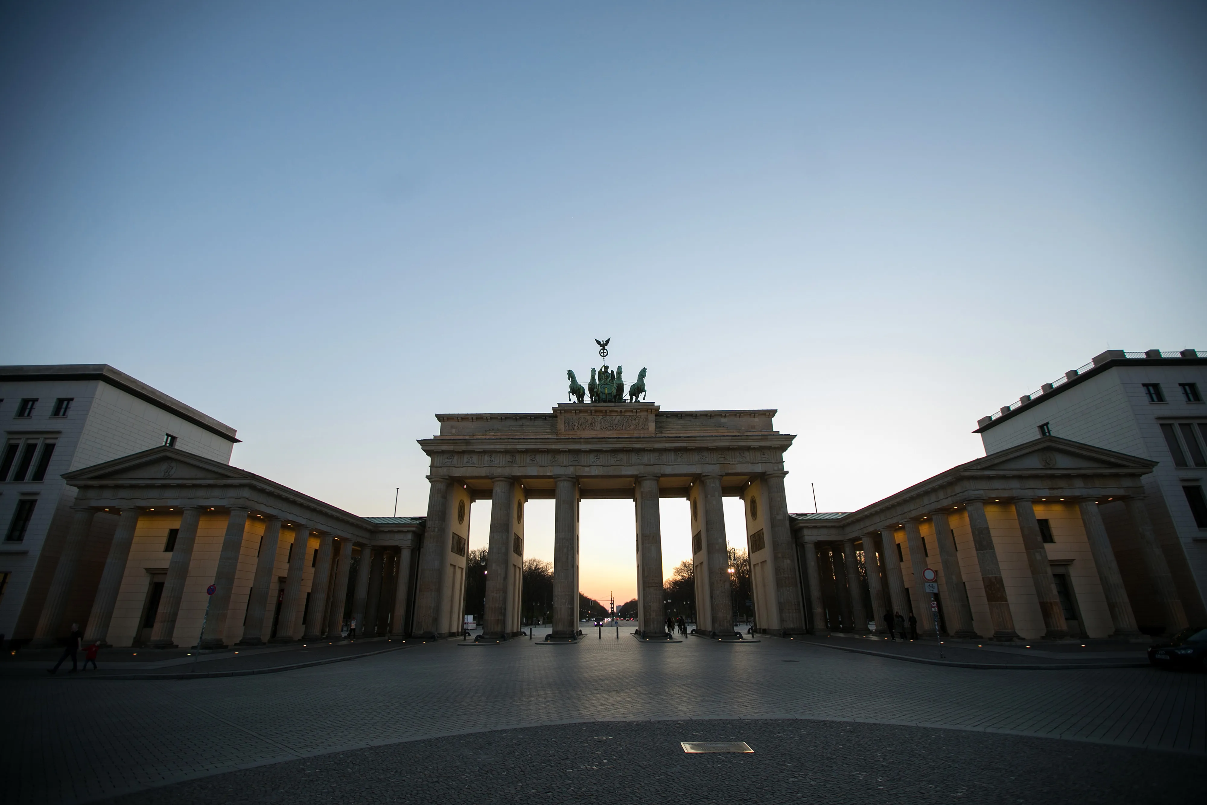 The Brandenburg Gate monument stands in an empty Pariser Platz square at dusk in Berlin on April 7.