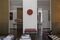 A red hat from Indonesia hangs on a wall that leads to the gallery.