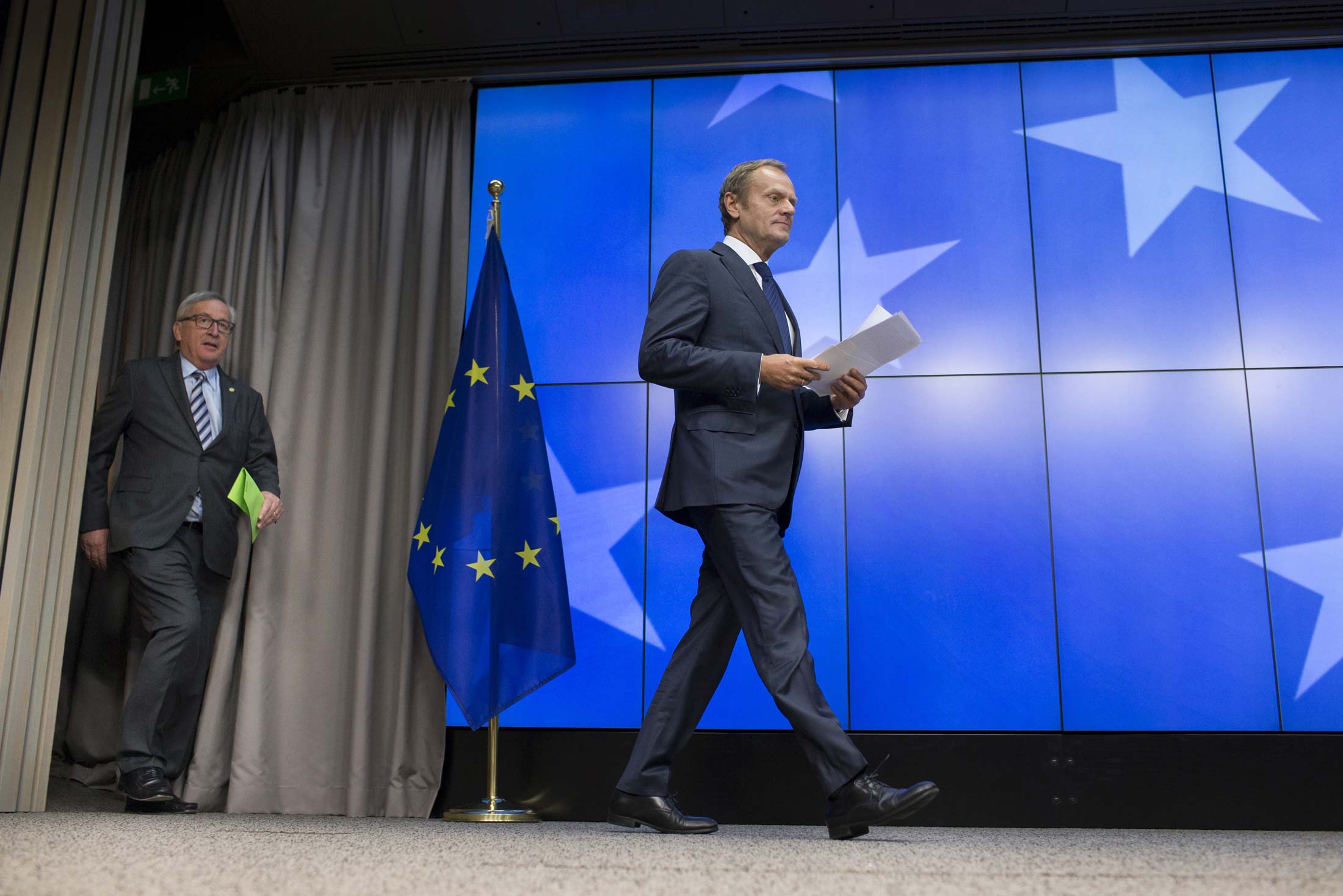 Jean-Claude Juncker, president of the European Commission, left, and Donald Tusk, president of the European Council, arrive for a news conference during a meeting of EU leaders in Brussels on June 29.
