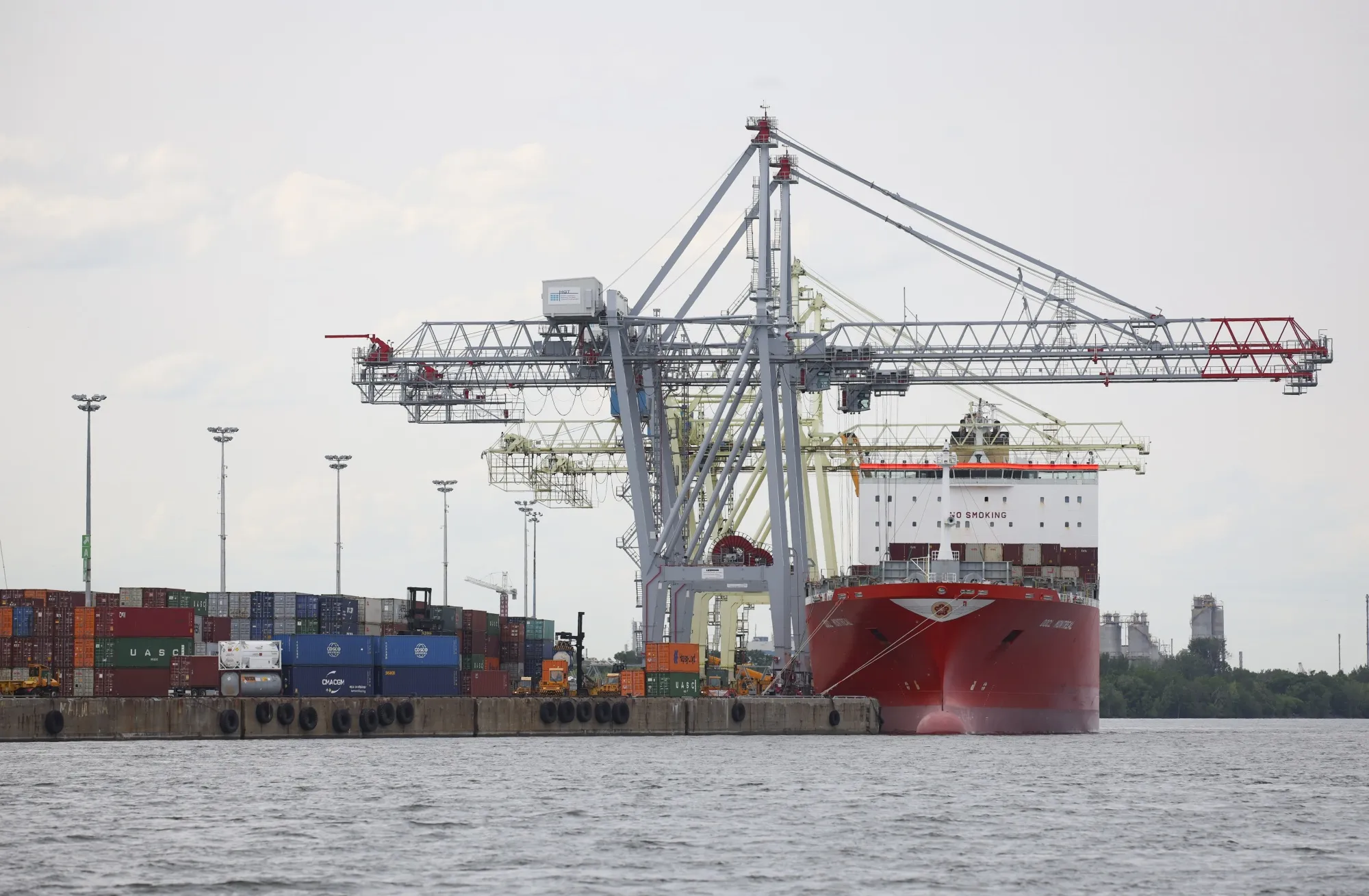 A container ship sits berthed at the Port of Montreal in June.