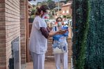 Field researchers disinfect their hands as they depart the home of a Covid-19 positive patient in Sant Antoni de Vilamajor, Spain.
