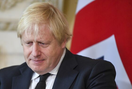Boris Johnson Warns of Omicron Danger as U.K. Eases Test Rules to Cope
