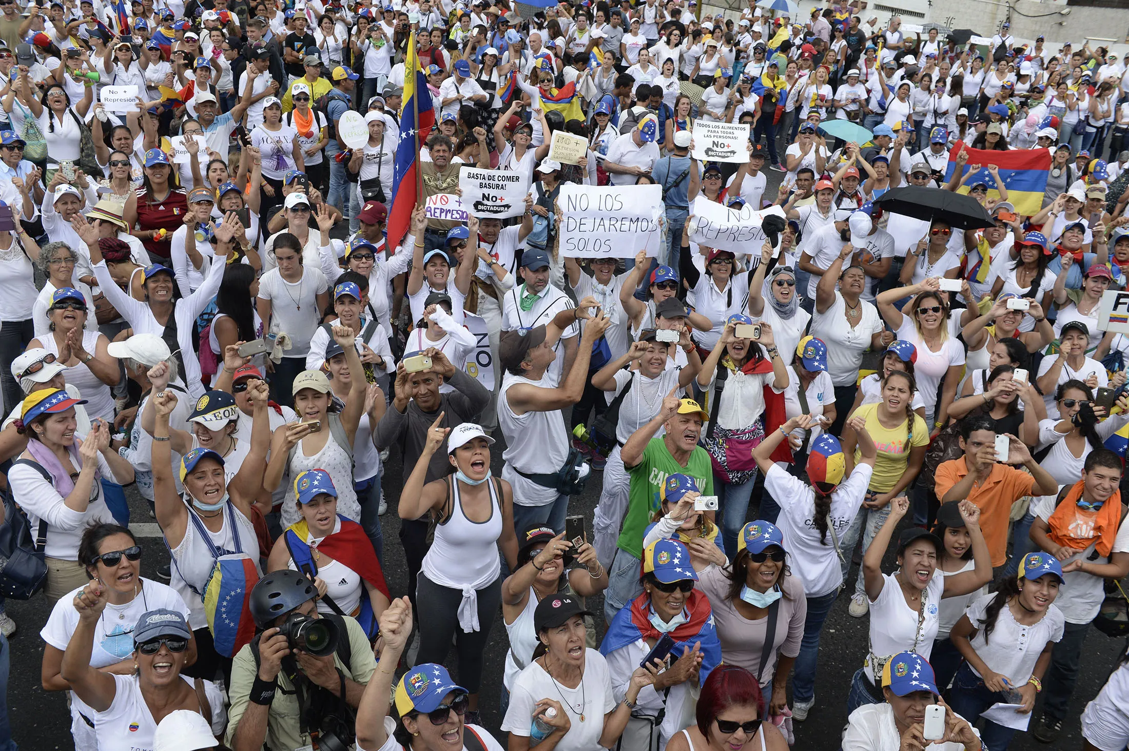 Venezuelan opposition activists take part in a women's march aimed to keep pressure on President Nicolas Maduro, whose authority is being increasingly challenged by protests and deadly unrest, in Caracas on May 6, 2017.
