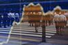Pedestrians crossing the road are reflected in an electronic stock board outside a securities firm in Tokyo, Japan, on Friday, June 9, 2017.