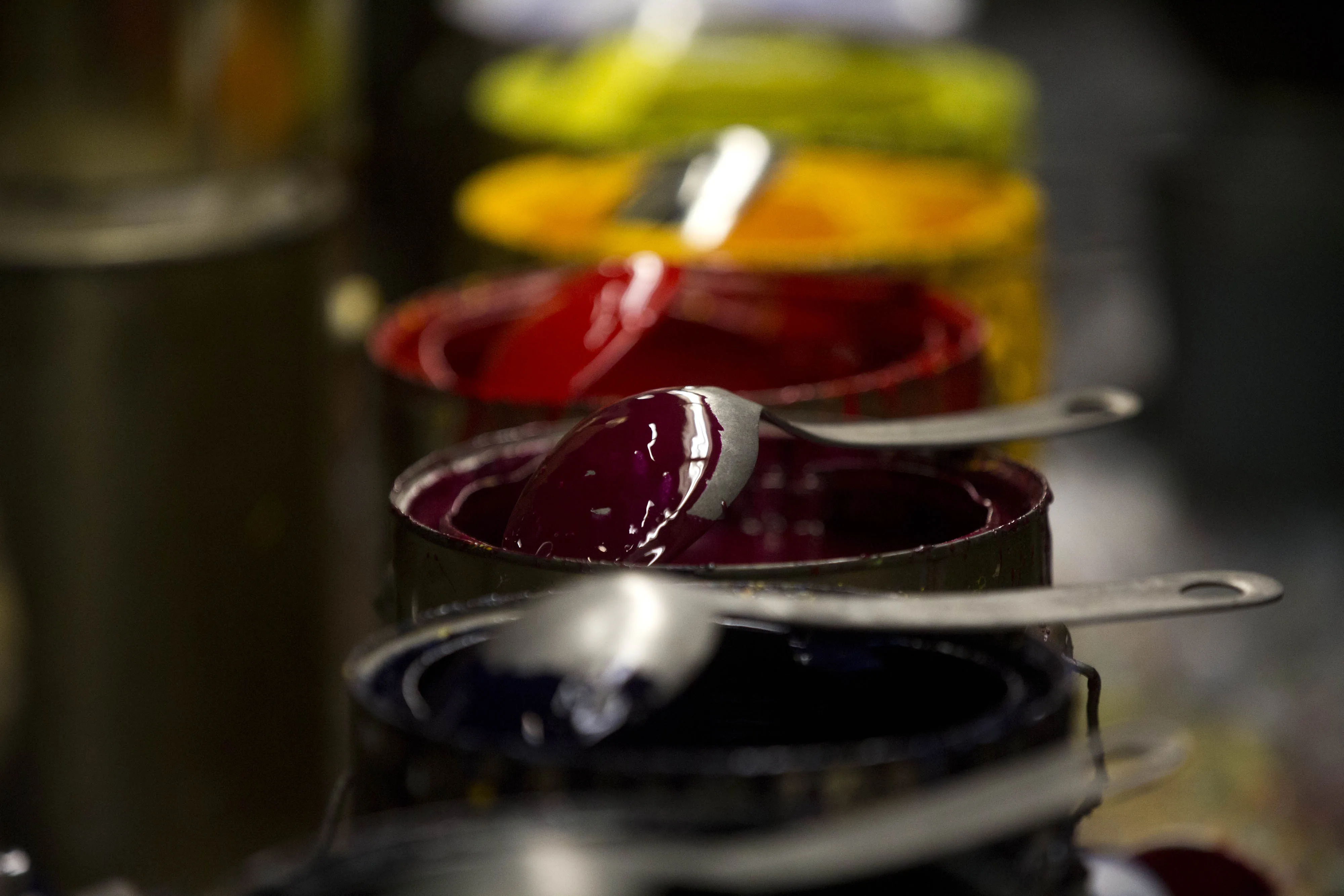 Paint used to color zipper sliders sits on a table during production at the UCAN Zipper manufacturing facility in Los Angeles, California, U.S., on Tuesday, Oct. 12, 2015. UCAN Zippers only factory produces 11,588 yards of zipper chain per year and paints 24,320 zipper sliders per day.