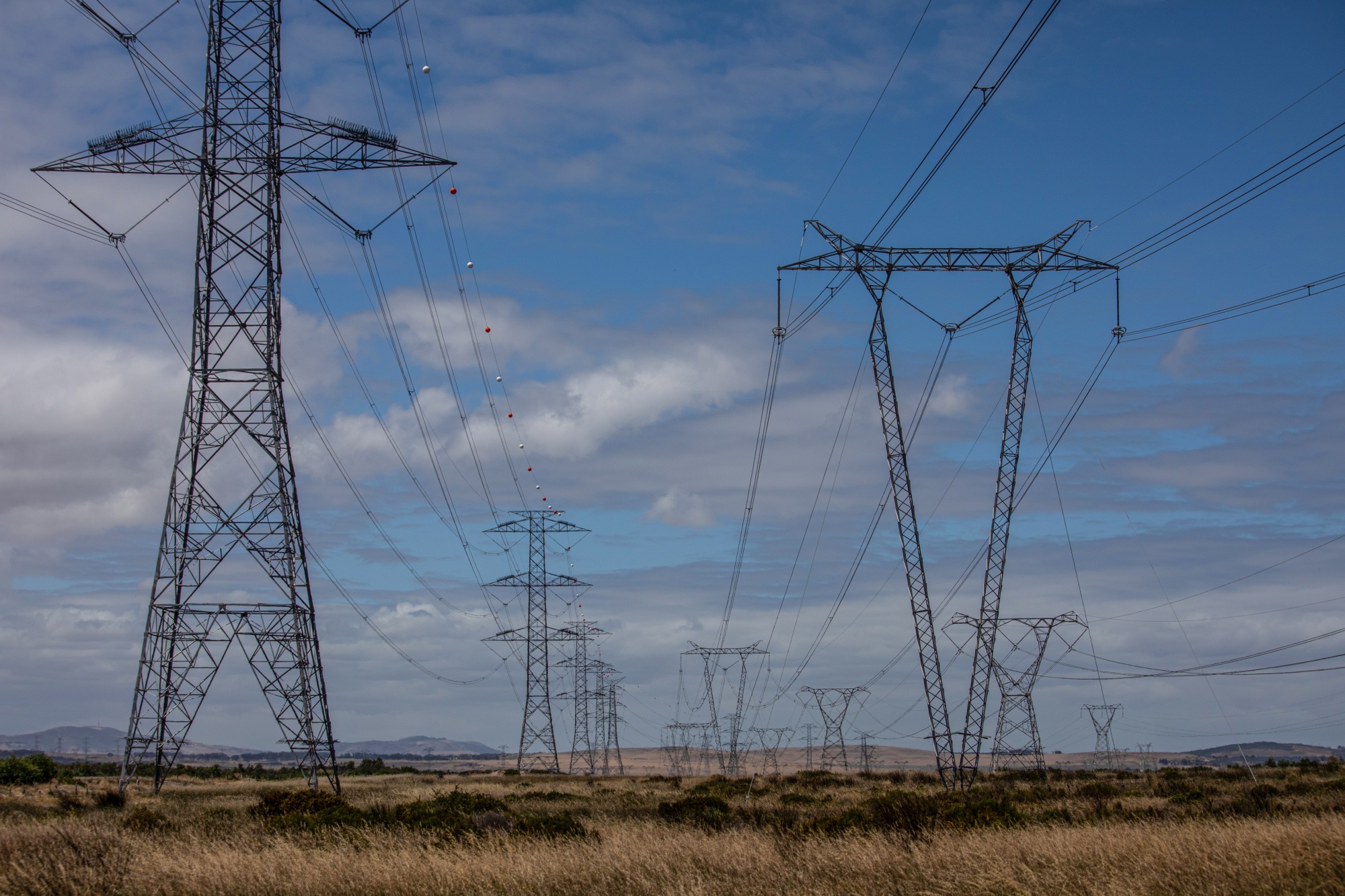 Electricity transmission pylons close to Koeberg&nbsp;nuclear power station, operated by Eskom Holdings SOC Ltd., in Cape Town, South Africa.