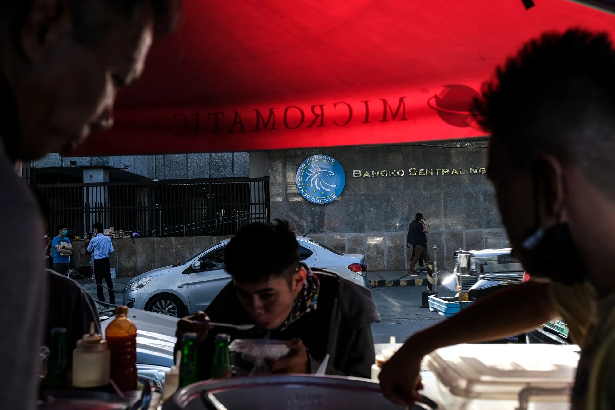 A food stall across the road from an entrance to the Bangko Sentral ng Pilipinas headquarters complex in Manila.