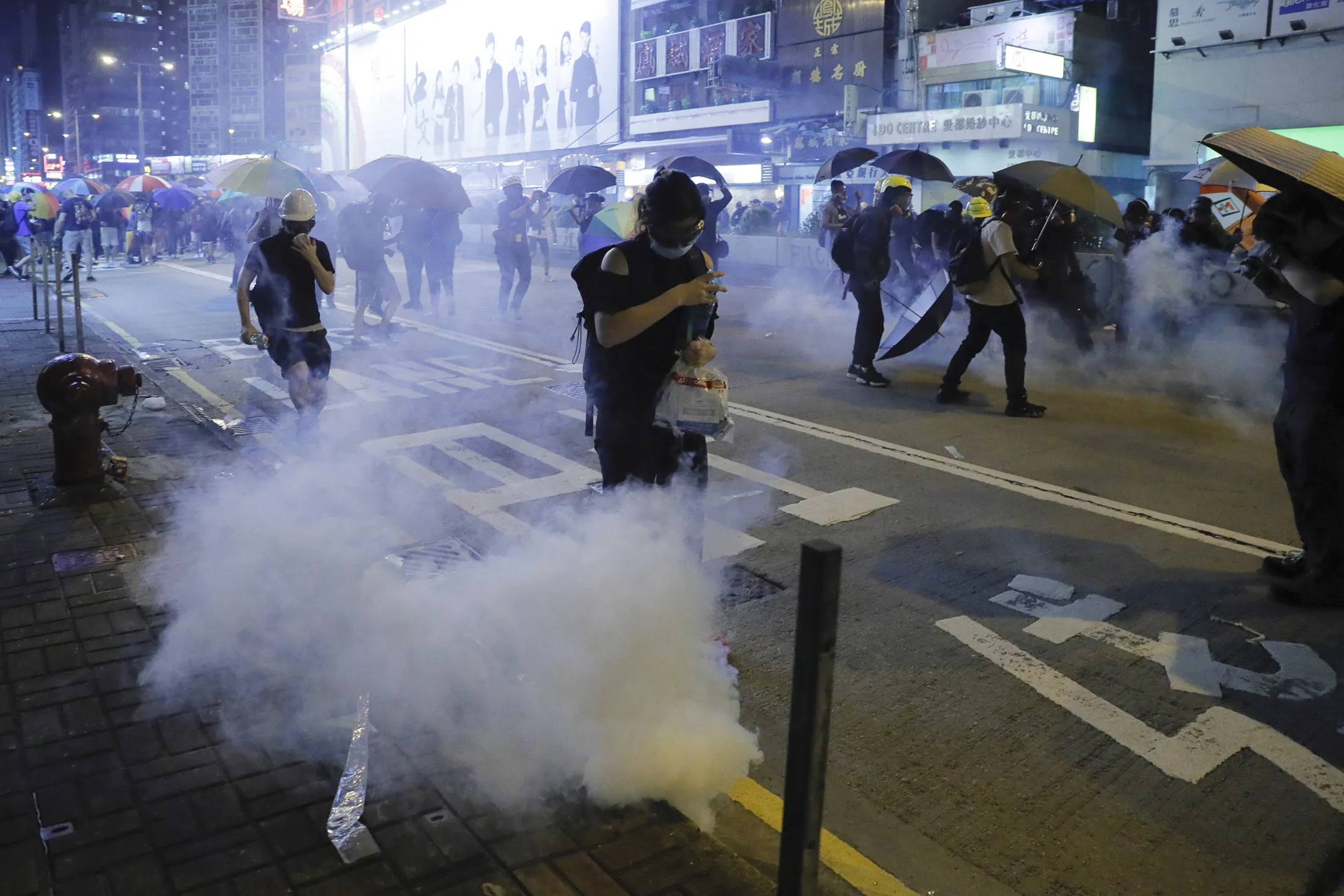 Protestors run for cover from tear gas shells during a protest in Hong Kong on&nbsp;Sept. 6, 2019.&nbsp;