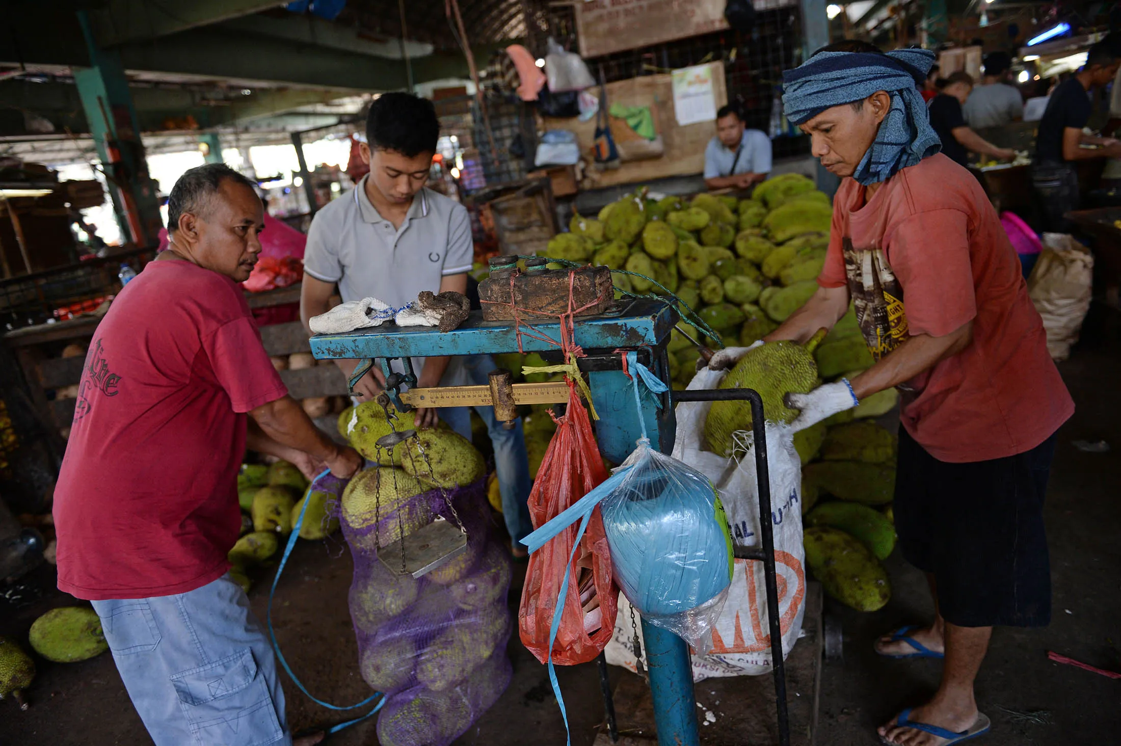 Vendors pack jackfruits at the Pasar Induk Kramat Jati market in Jakarta, Indonesia.
